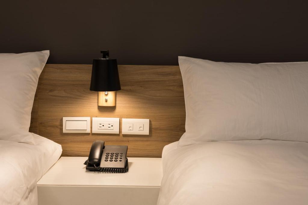 Letto o letti in una camera di Greenight Hotel