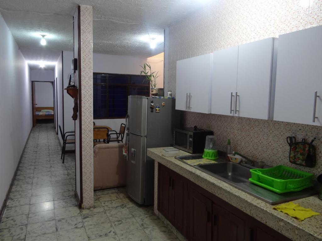 a kitchen with a sink and a refrigerator at Apartamento de recuperación in Cali
