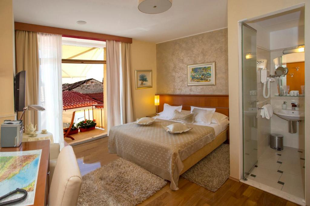a hotel room with a bed and a window at Royal Suites in Split