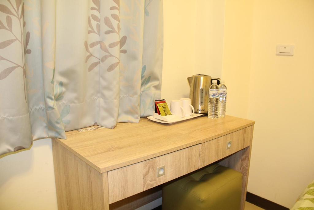 a wooden table in a room with a window at 八八小屋心享民宿 in Jinning