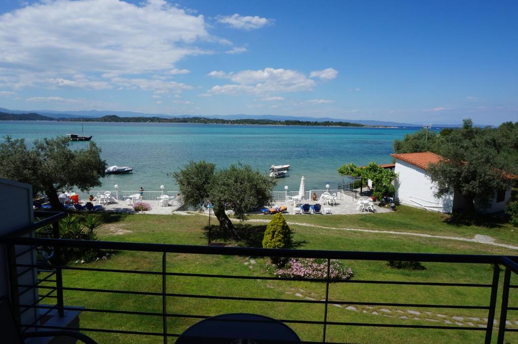 a view of a body of water from a balcony at Vourvourou Hotel in Vourvourou