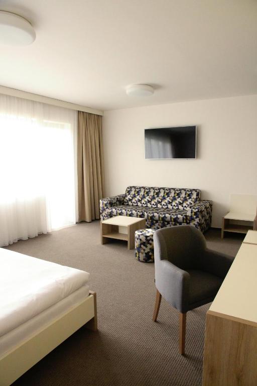 Postel nebo postele na pokoji v ubytování Hotel Devítka