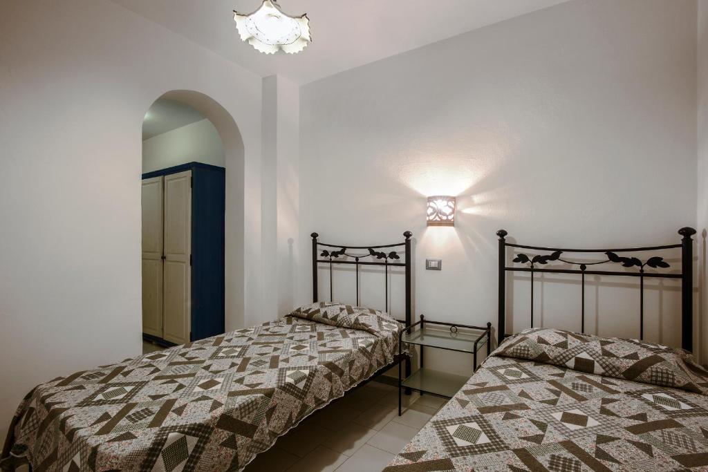 Postel nebo postele na pokoji v ubytování Magi - Appartamenti Maga Circe
