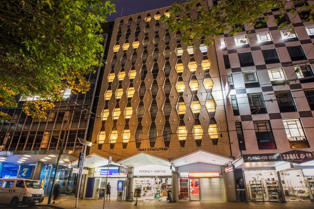 a building on a street in a city at night at Quest On Lambton Serviced Apartments in Wellington