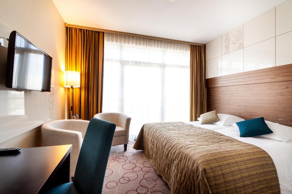 Łóżko lub łóżka w pokoju w obiekcie Qubus Hotel Kraków
