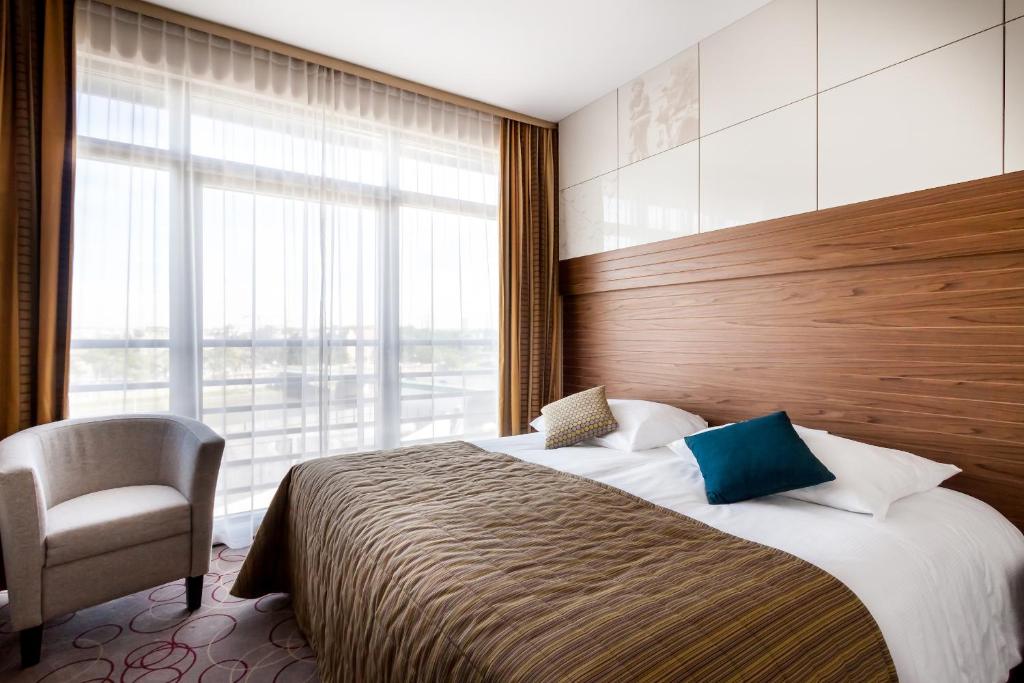Łóżko lub łóżka w pokoju w obiekcie Qubus Hotel Kraków