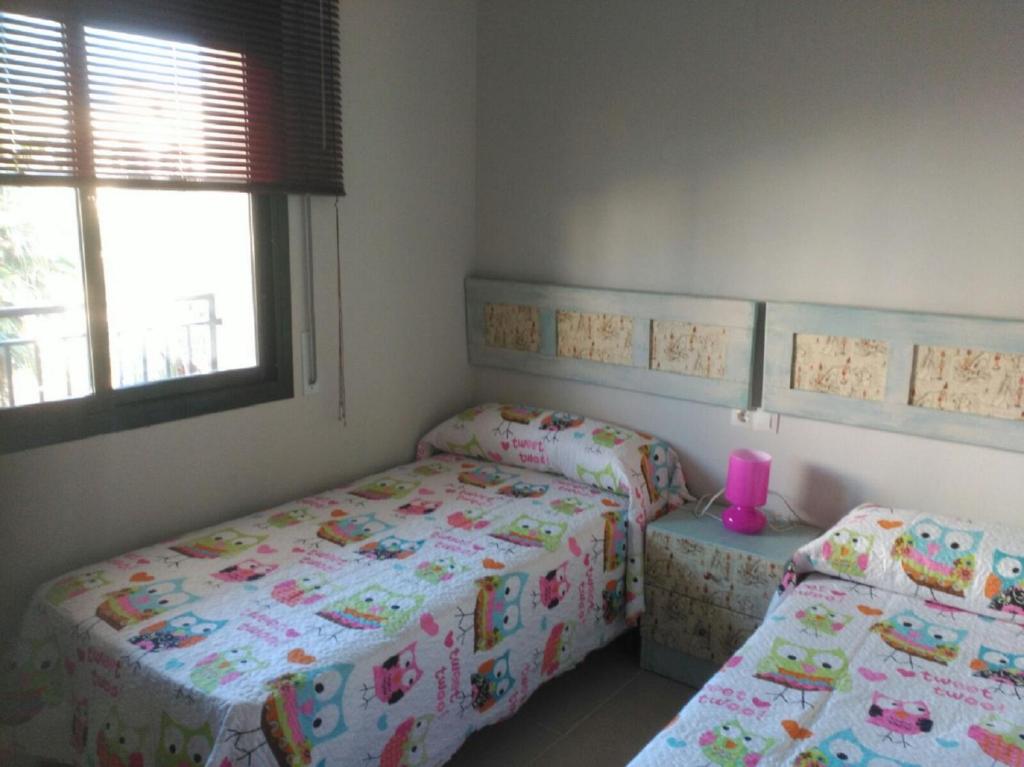 Postel nebo postele na pokoji v ubytování Residencial La Cala