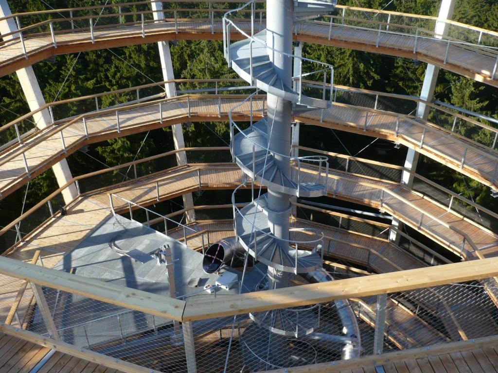 a spiral staircase in the middle of a building at Apartmán Zlatá Vyhlídka in Janske Lazne