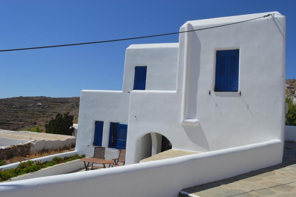 a view of a white house with blue doors and windows at Superb view House-Sikinos Island-Chorio in Síkinos