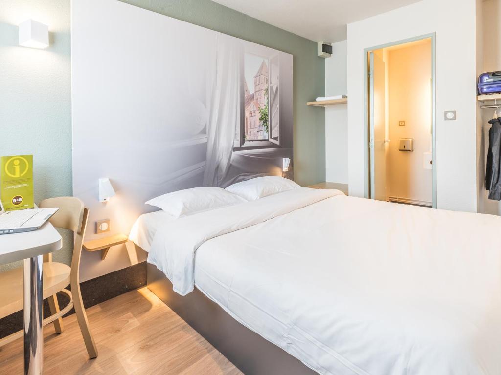 Postel nebo postele na pokoji v ubytování B&B HOTEL Strasbourg Sud Geispolsheim