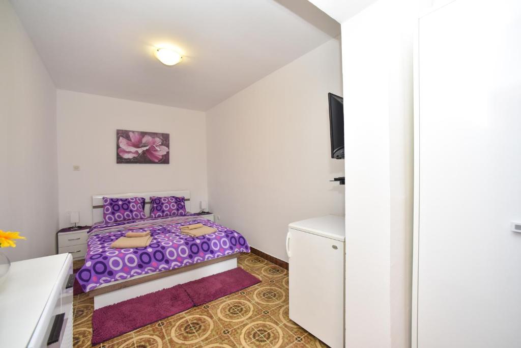 Postel nebo postele na pokoji v ubytování MG apartments and rooms