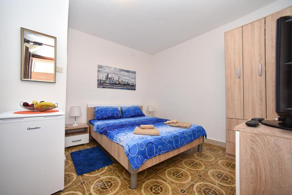 Postel nebo postele na pokoji v ubytování MG apartments and rooms