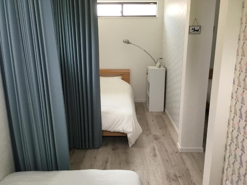 Postel nebo postele na pokoji v ubytování Guesthouse ORI ORI