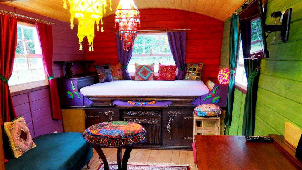 a room with a bed and a table and chairs at Chata w Rabce - Bajkowa Osada in Rabka