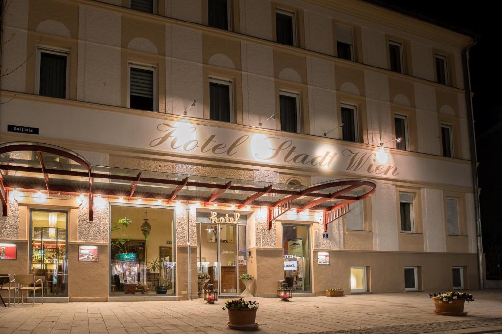 ein Geschäft vor einem Gebäude in der Nacht in der Unterkunft Hotel Stadt Wien in Bad Schallerbach