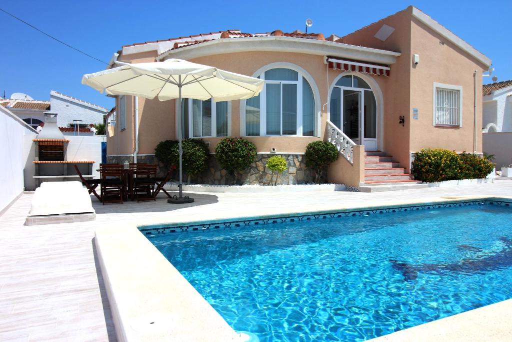 ein Haus mit einem Pool vor einem Haus in der Unterkunft Casa Bruno in Ciudad Quesada