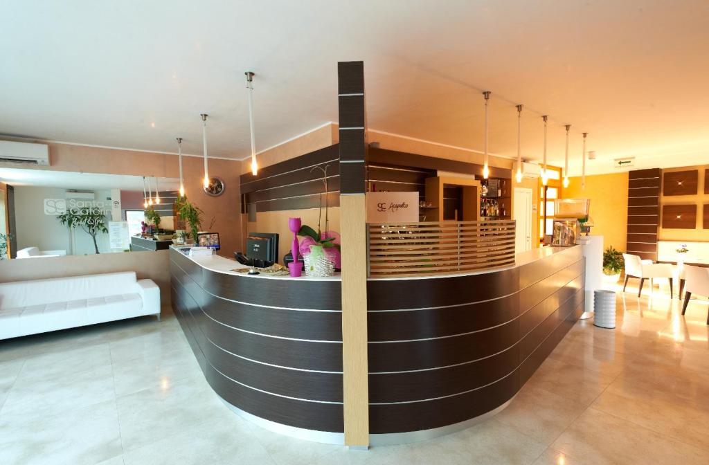 a lobby with a bar in the center of a building at Santa Caterina Resort in Santa Caterina di Nardò