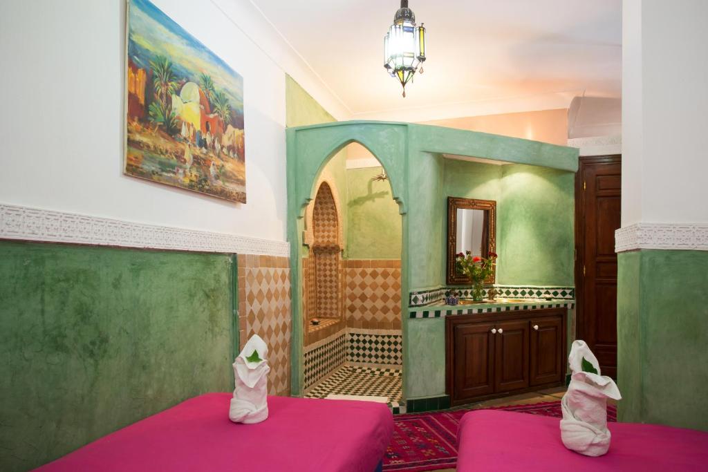 Postel nebo postele na pokoji v ubytování Riad Zanzibar