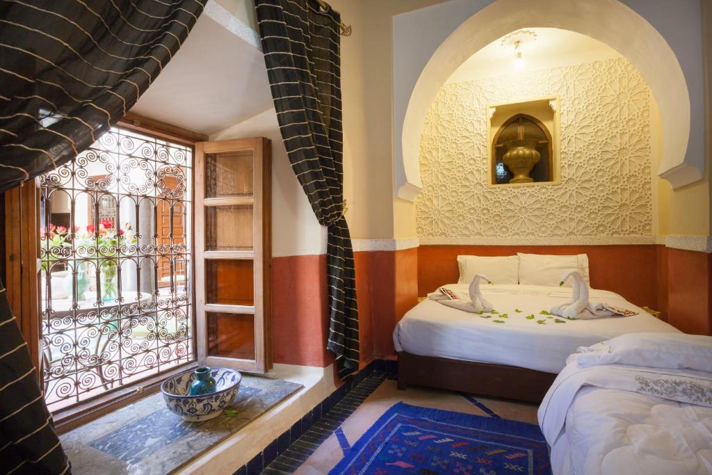 Postel nebo postele na pokoji v ubytování Riad Zanzibar