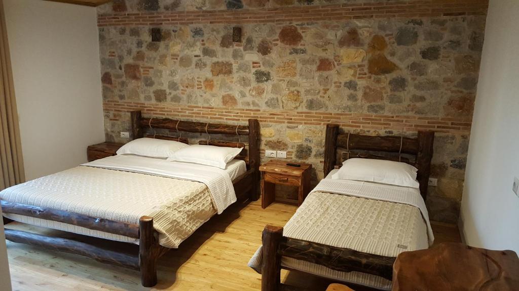 Postel nebo postele na pokoji v ubytování Hotel Bujtina Ollga