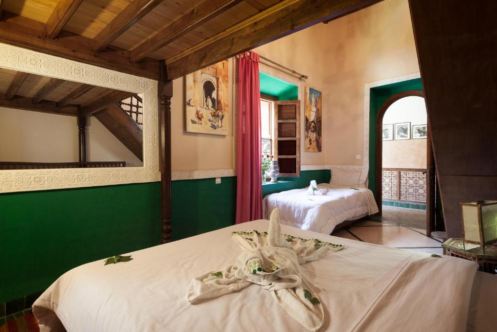 Postel nebo postele na pokoji v ubytování Riad Zanzibar