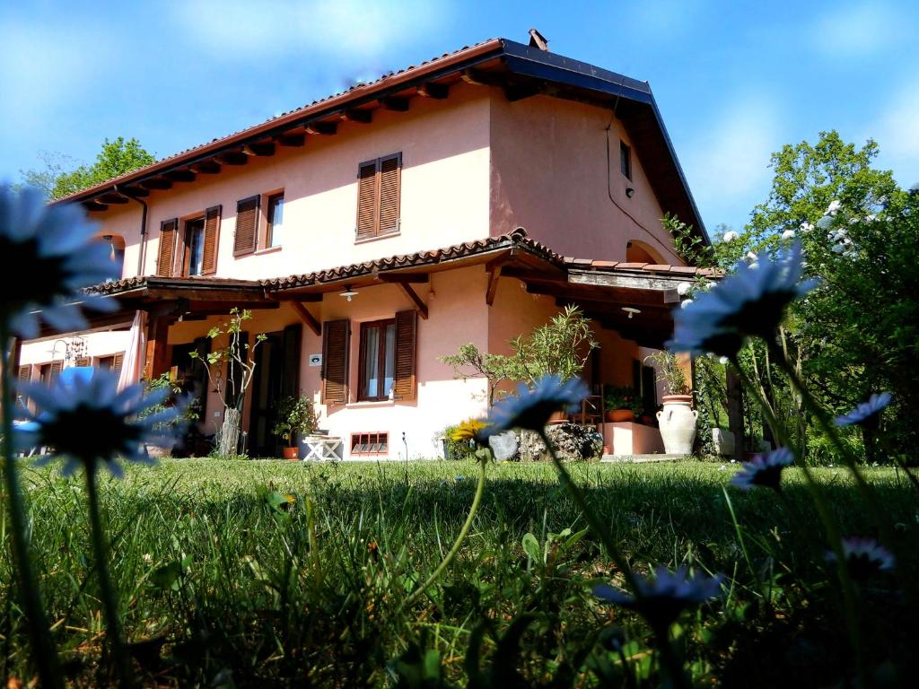 dom z niebieskimi kwiatami przed nim w obiekcie B&B Cascina Ciapilau w Asti