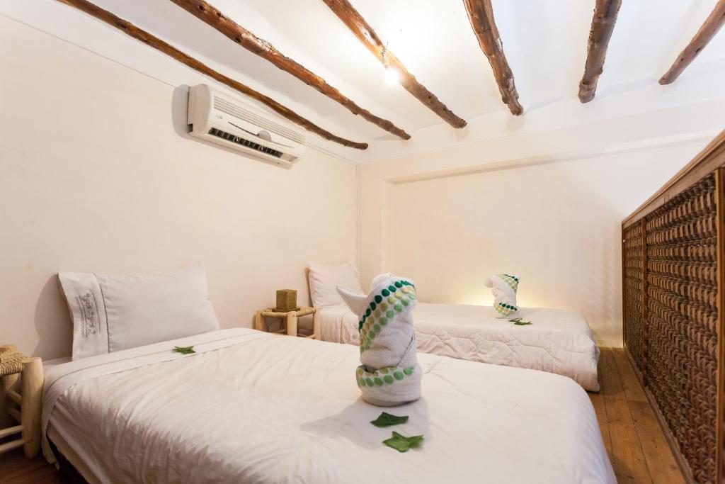 Postel nebo postele na pokoji v ubytování Riad Zanzibar