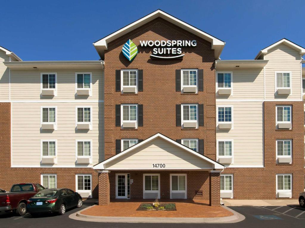 a building with a sign on the side of it at WoodSpring Suites Kansas City Lenexa in Lenexa