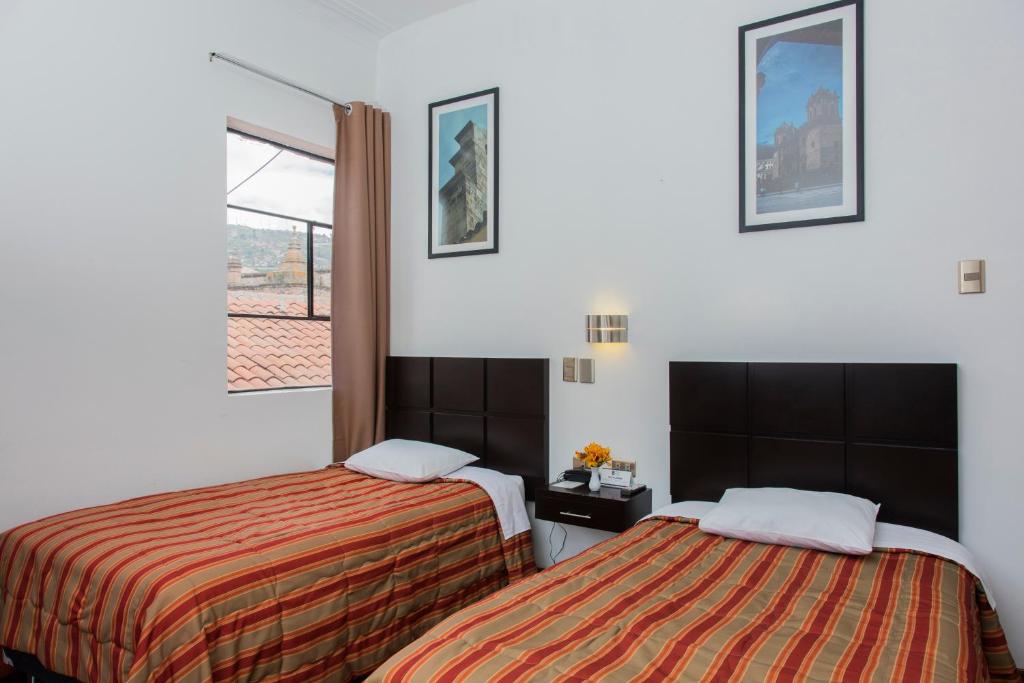Postel nebo postele na pokoji v ubytování Hostal & Apartments El Triunfo