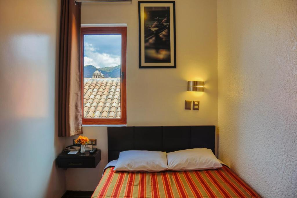 Postel nebo postele na pokoji v ubytování Hostal & Apartments El Triunfo