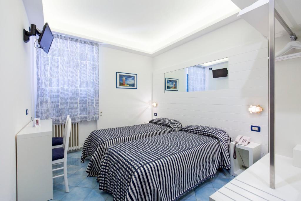 Postel nebo postele na pokoji v ubytování Hotel Il Faro