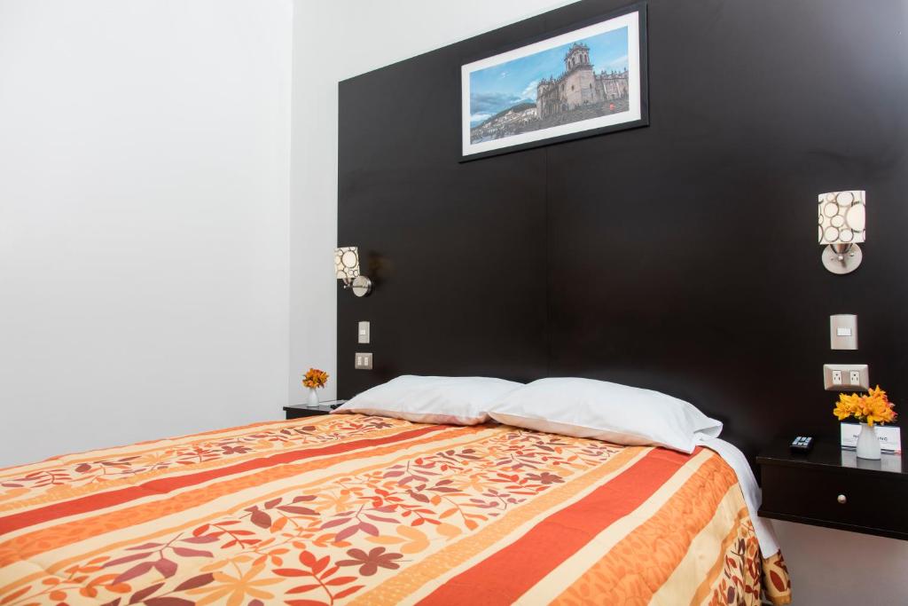 Postel nebo postele na pokoji v ubytování Hostal & Apartments El Triunfo