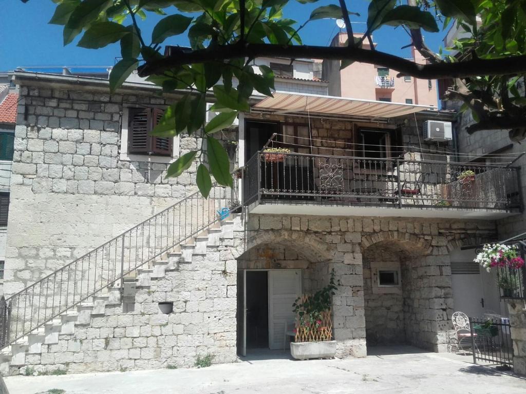 a building with a staircase and a balcony at Apartments and room Mari in Split