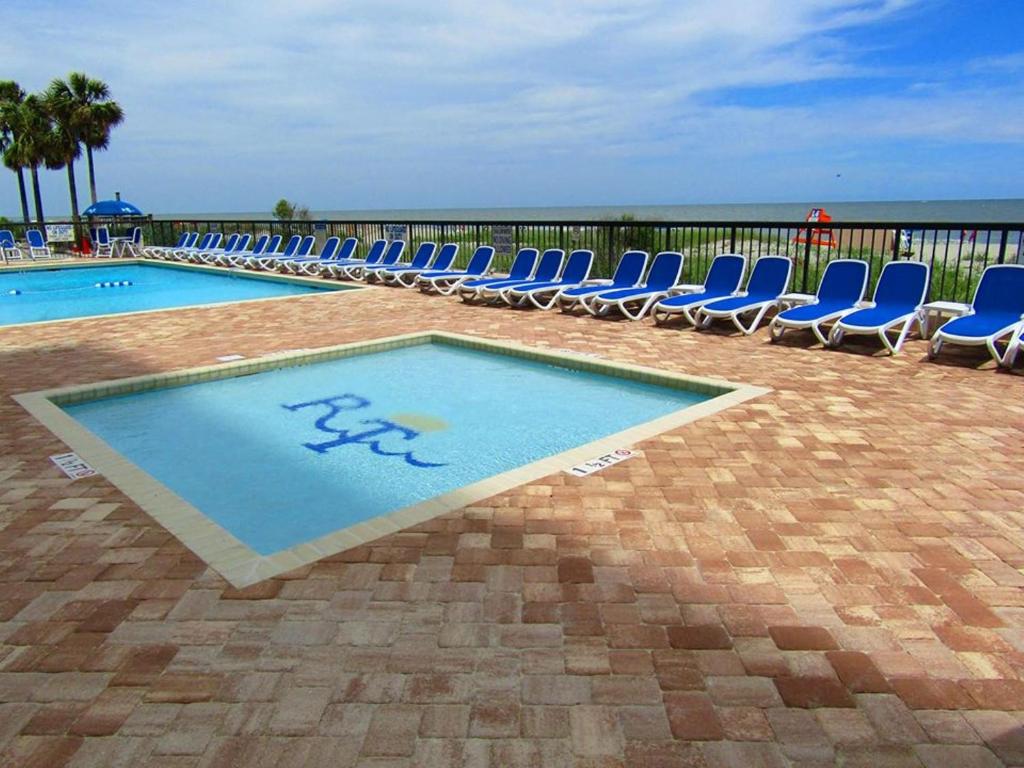 ein Swimmingpool mit Liegestühlen und ein Swimmingpool in der Unterkunft Club Regency at Regency Towers in Myrtle Beach