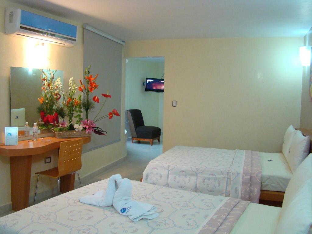 Postel nebo postele na pokoji v ubytování Auto Hotel Mediterráneo