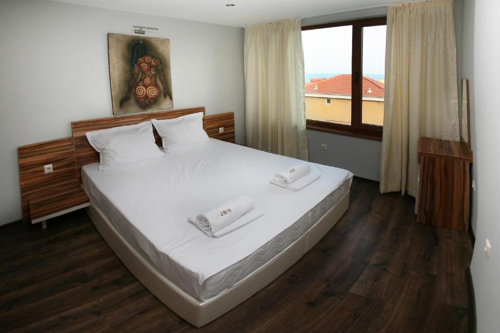 Postel nebo postele na pokoji v ubytování JBH Hotel