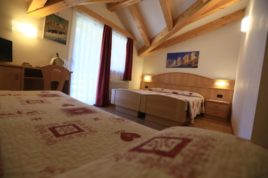 Postel nebo postele na pokoji v ubytování Hotel Miramonti