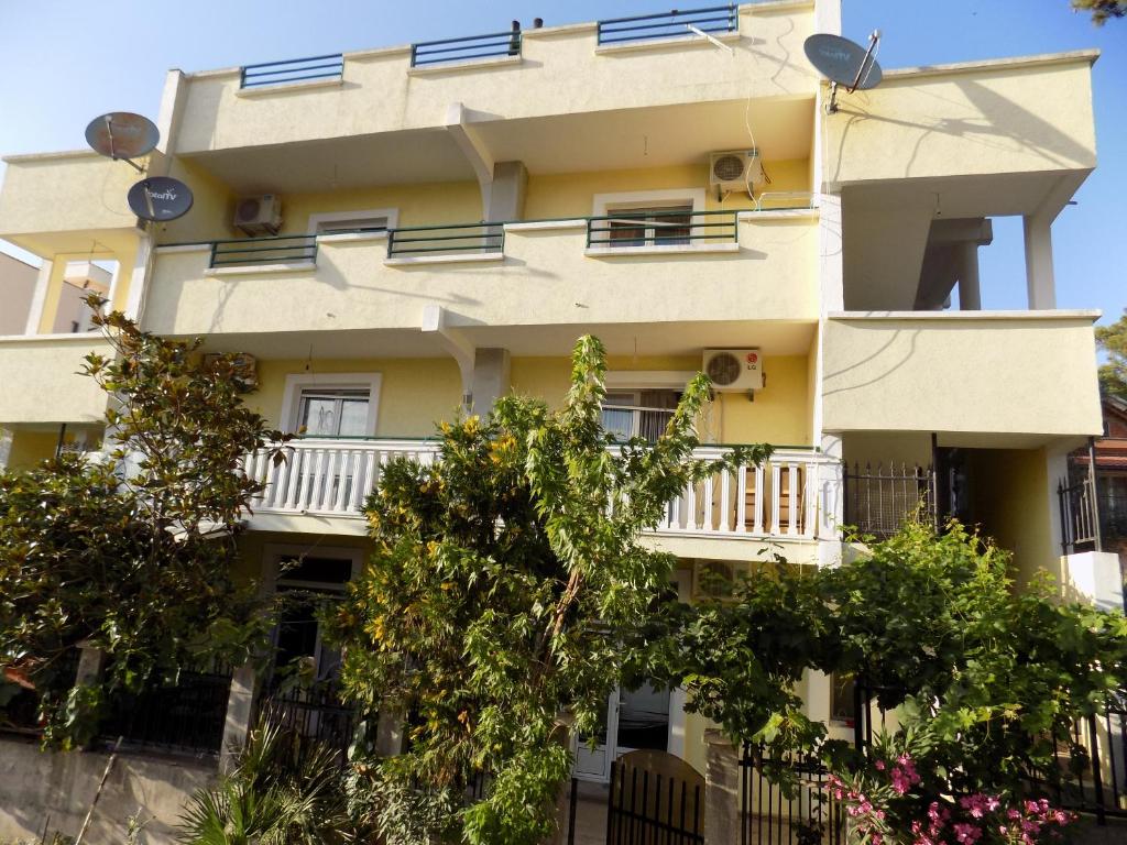 a building with balconies and trees in front of it at Apartments Mujovi in Bar