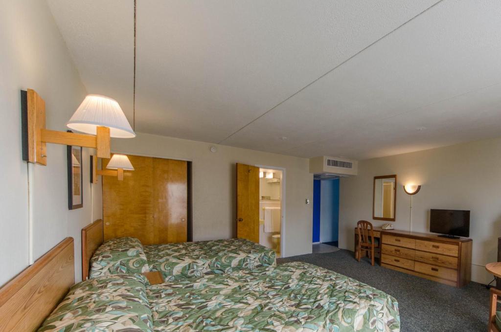 Postel nebo postele na pokoji v ubytování Attache Motel
