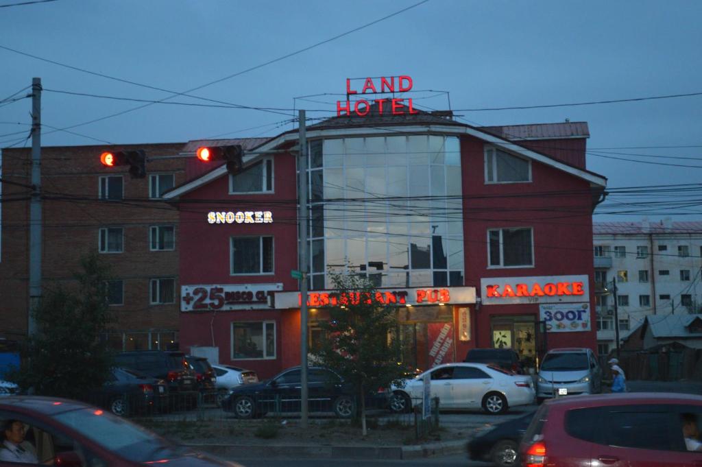 a red building with a sign that reads land hotel at Land Hotel in Ulaanbaatar