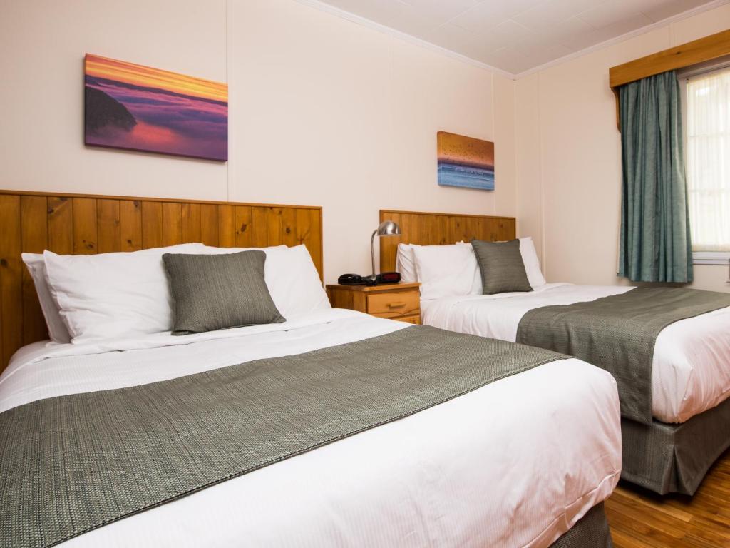 Postel nebo postele na pokoji v ubytování Au Pic de l'Aurore Motel-Chalets