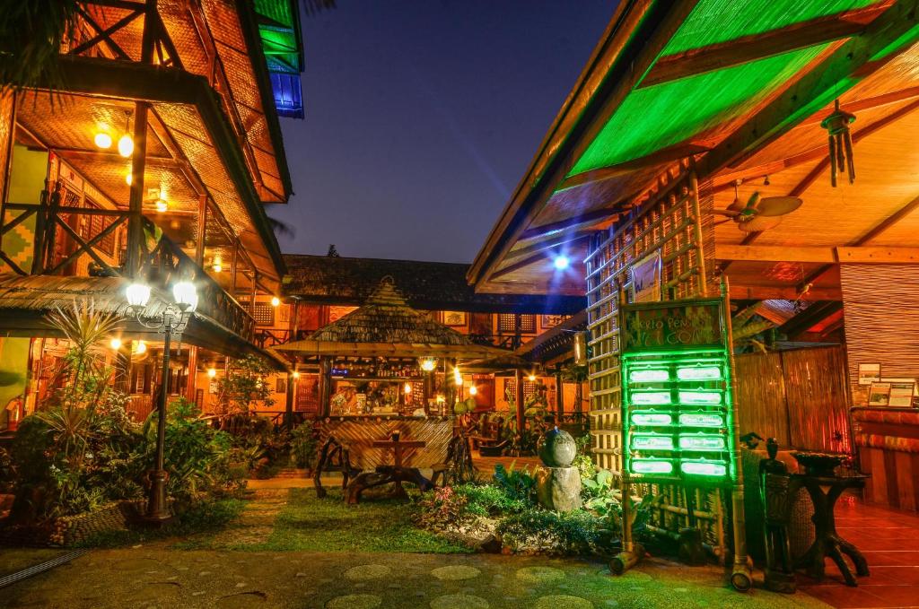 a building with a restaurant with lights on it at Puerto Pension Inn in Puerto Princesa City