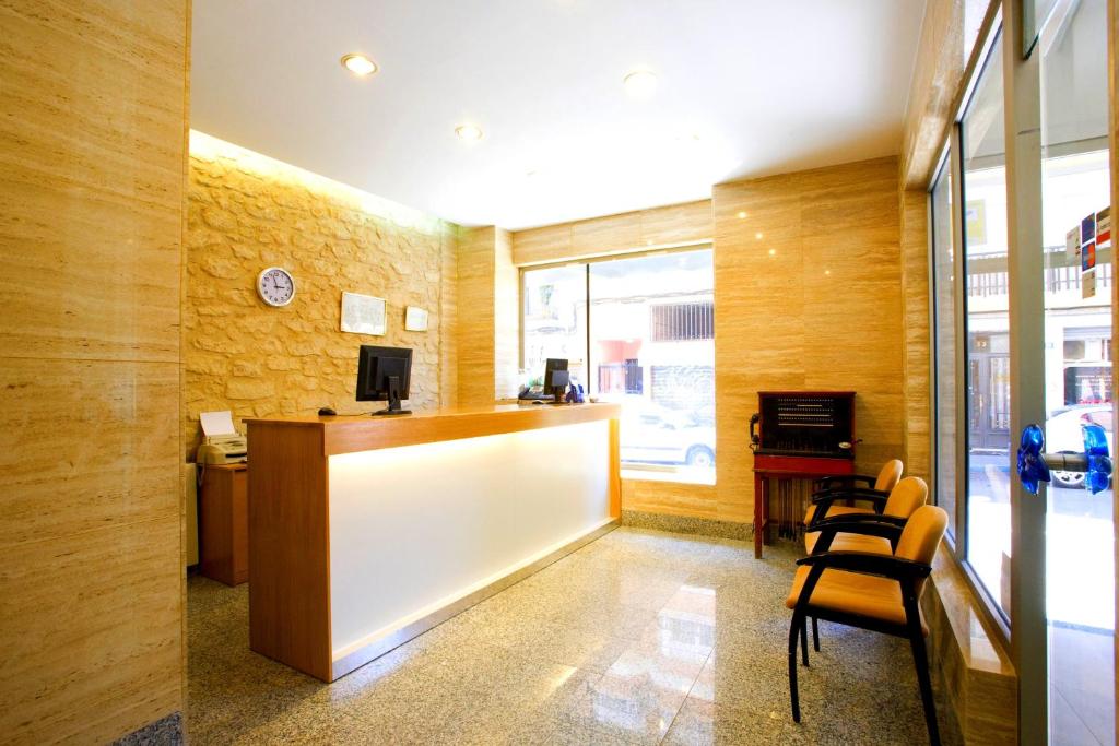 an office with a desk and chairs in a room at La Lonja in Alicante