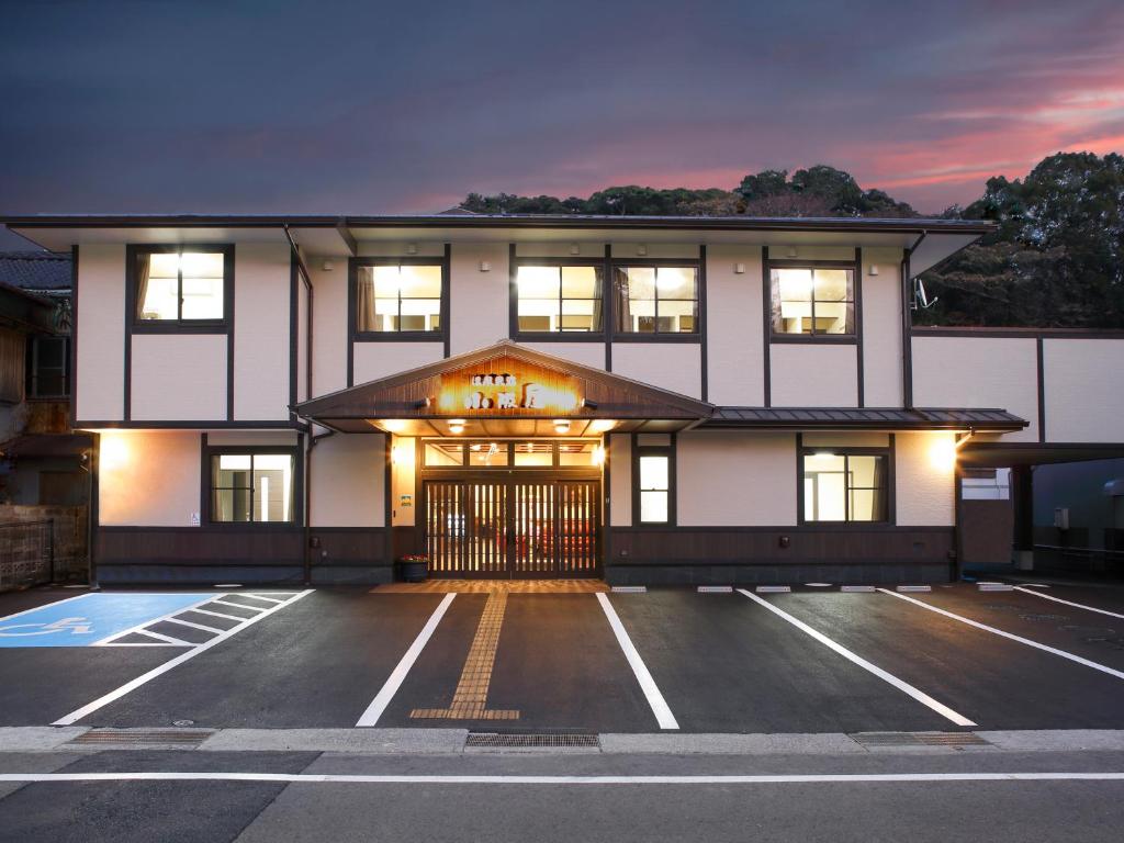 
a large building with a large window on the side of the building at Onsenminshuku Kosakaya in Katsuura

