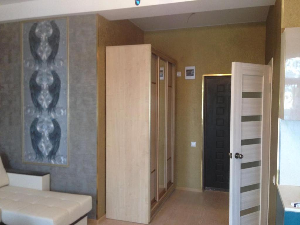 a room with a bed and a closet and a door at Hotel Complex Mary in Orenburg