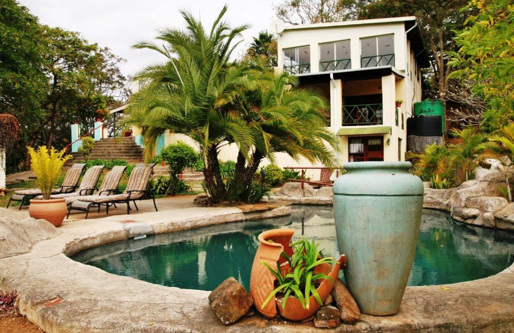 a house with a swimming pool in front of a house at Haus Kopatsch in Hazyview