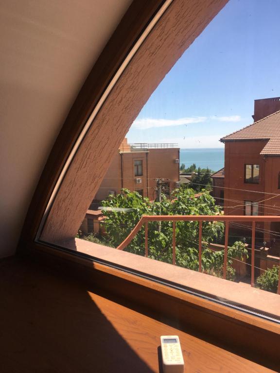 a window with a view of the ocean from a building at Veranda Guest House in Chornomorsk