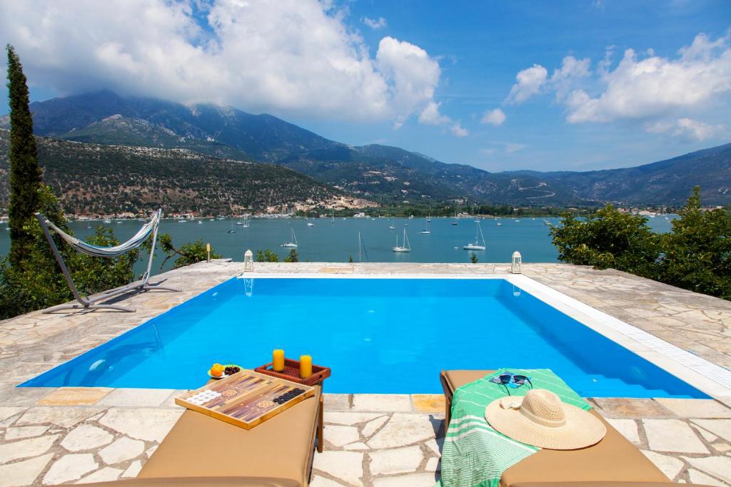 a swimming pool with a view of the water at Villa Panorea in Yénion
