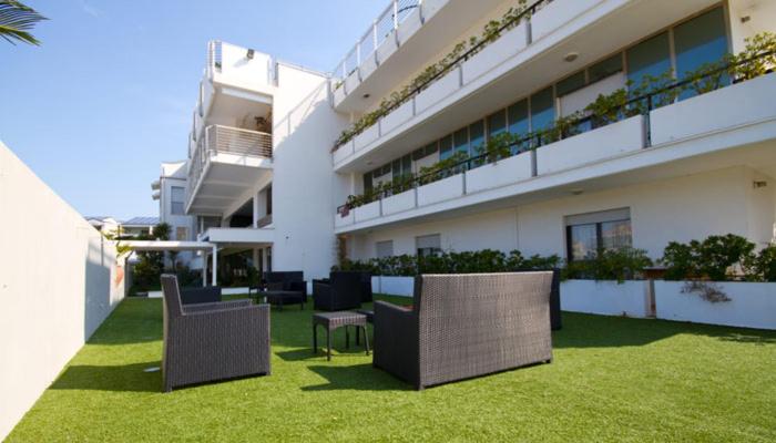 a building with chairs on the lawn in front of it at Hotel L'Aragosta in Casalbordino