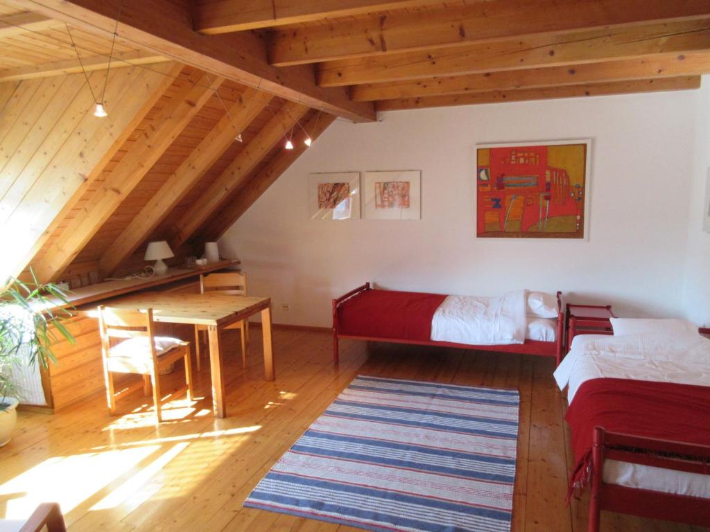 a living room with a bed and a table at Gästezimmer Paul in Lindau